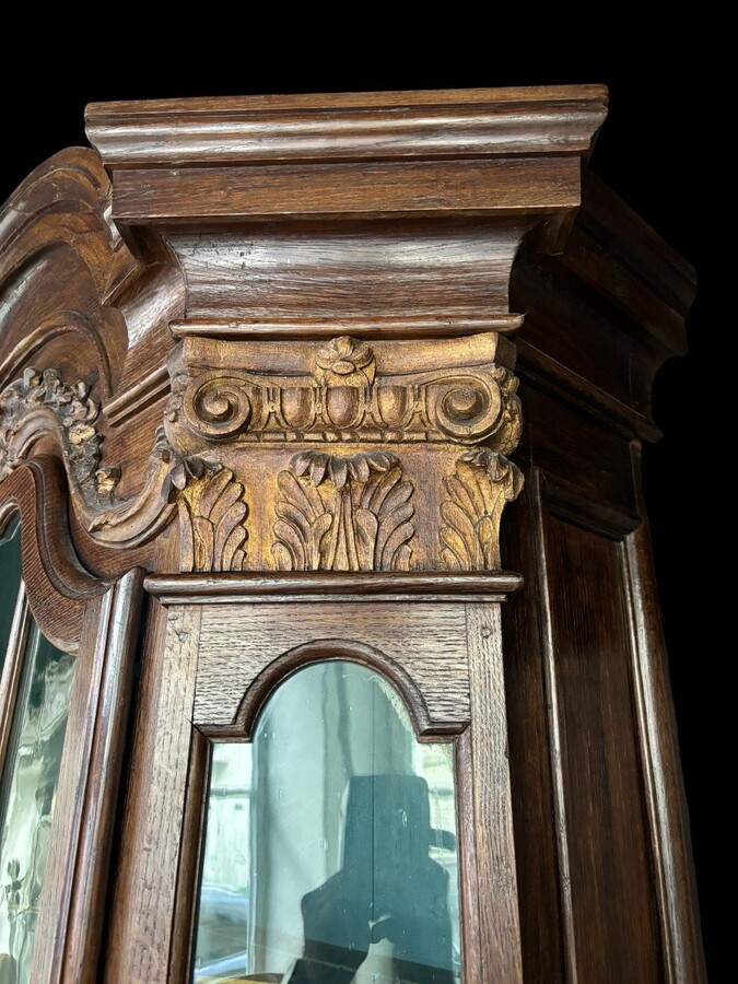 Beautiful 18thC. Castle display cabinet in oak Furniture with chamfered corners , large curved cornice , 1 large display door at the top , 2 paneled doors at the bottom Decorated at the top with wooden gilt decorative elements and capitals.
