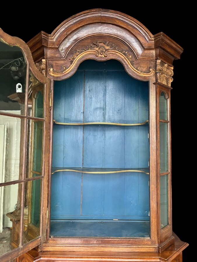 Beautiful 18thC. Castle display cabinet in oak Furniture with chamfered corners , large curved cornice , 1 large display door at the top , 2 paneled doors at the bottom Decorated at the top with wooden gilt decorative elements and capitals.