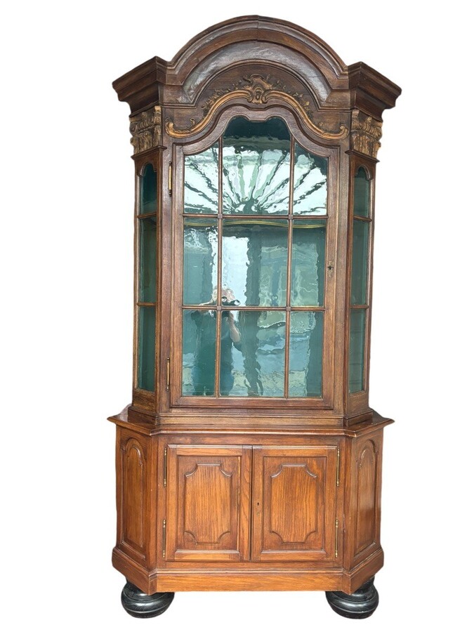 Beautiful 18thC. Castle display cabinet in oak Furniture with chamfered corners , large curved cornice , 1 large display door at the top , 2 paneled doors at the bottom Decorated at the top with wooden gilt decorative elements and capitals.