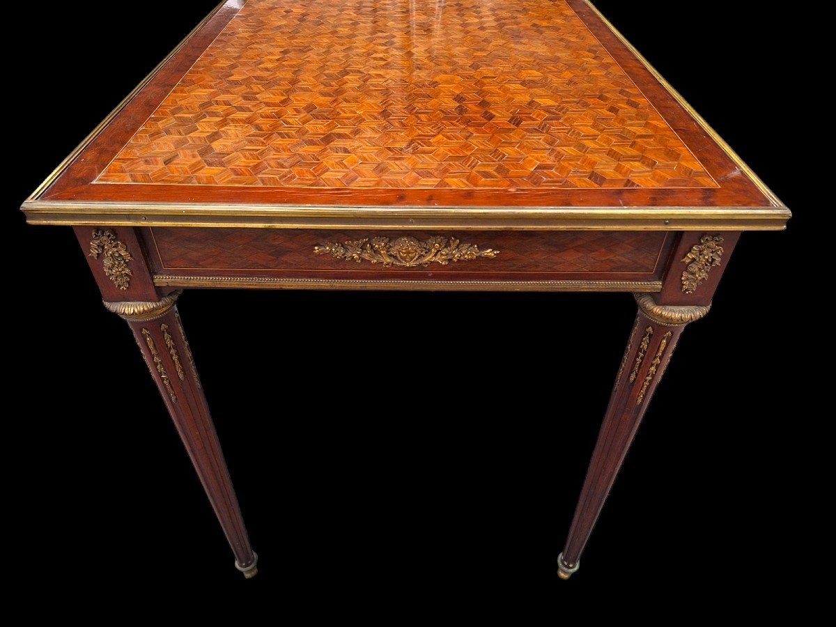 Beautiful Louis XVI style coffee table/desk after Jean-Henri Riesener, 19th century. High-quality desk with parquet top, equipped with a large drawer and decorated with very refined bronze decorations and ornaments.