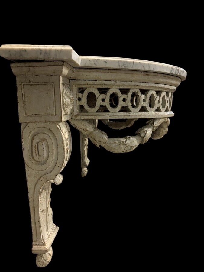 Beautiful Louis XVI style wall console in 18th century painted wood. Very decorative curved console in the Louis XVI style, decorated with girlandes with its original white marble. Dimensions : Height : 62 cm Width : 94,5 cm Depth : 51 cm