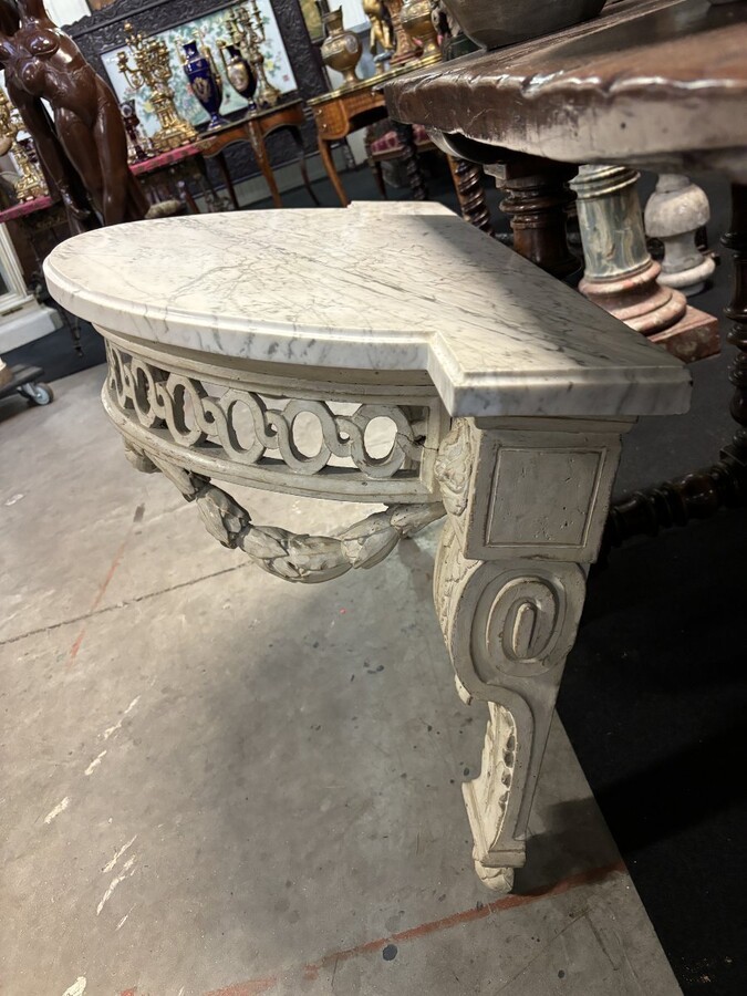 Beautiful Louis XVI style wall console in 18th century painted wood. Very decorative curved console in the Louis XVI style, decorated with girlandes with its original white marble. Dimensions : Height : 62 cm Width : 94,5 cm Depth : 51 cm