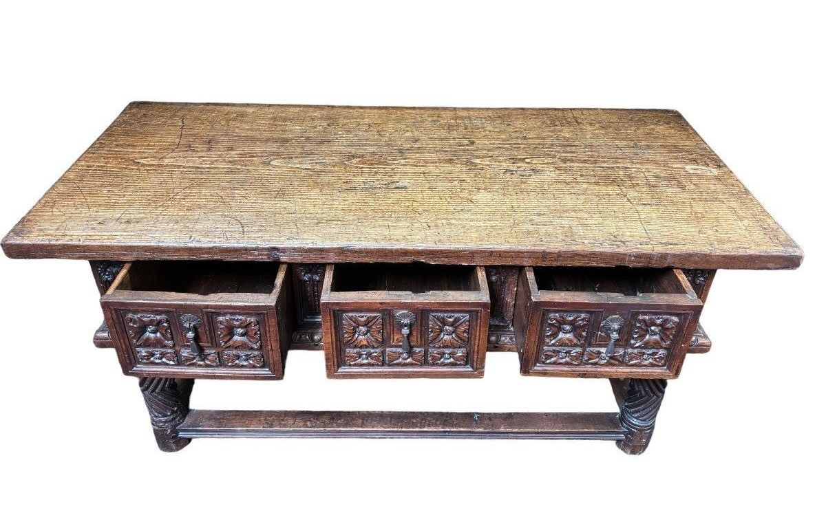 Beautiful Spanish table in Chestnut wood 17th century. Large sturdy table finished on 4 sides with beautiful wood carved decorations and fitted with 3 large drawers at the front. Beautiful thick top of 5 cm. Table in good condition