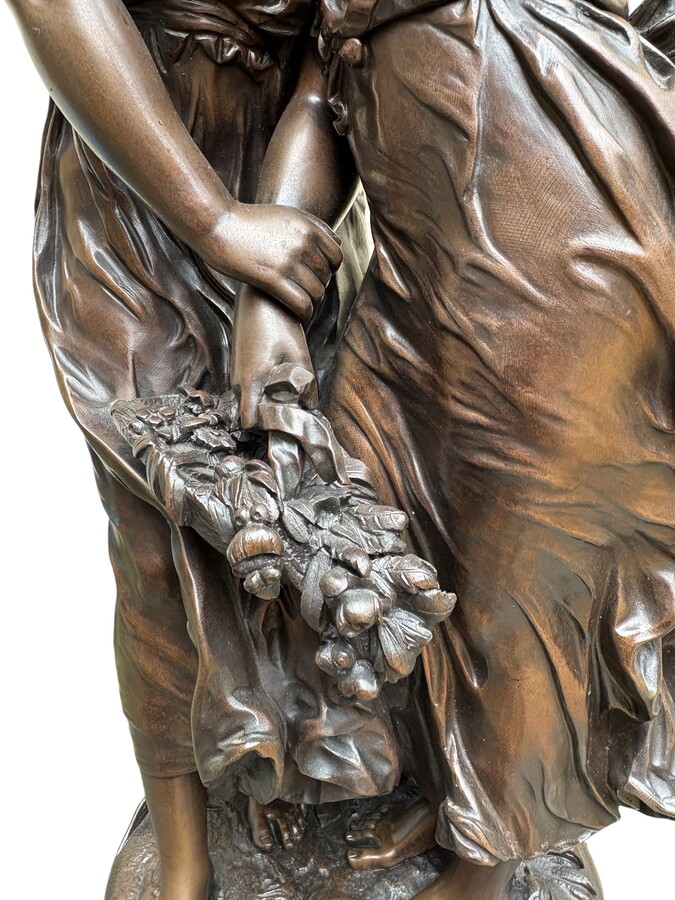 bronze sculpture depicting a young woman with a little girl carrying a basket of flowers. Very finely detailed, signed by Hippolyte Moreau and has a beautiful brown patina. François-Hippolyte Moreau (Dijon 1832–Neuilly-sur-Seine 1926) 