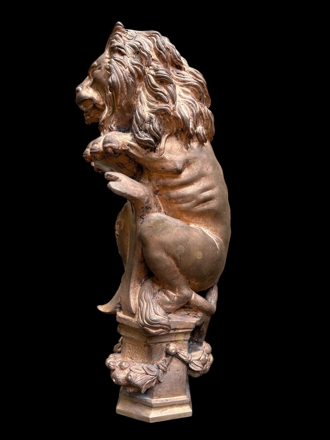 Bronze statuette representing a lion with a coat of arms decorated with a fleur-de-lis, dating from the 19th century. Decorative statuette of French origin dating from the late 19th century. In good condition, the gilding is worn. 