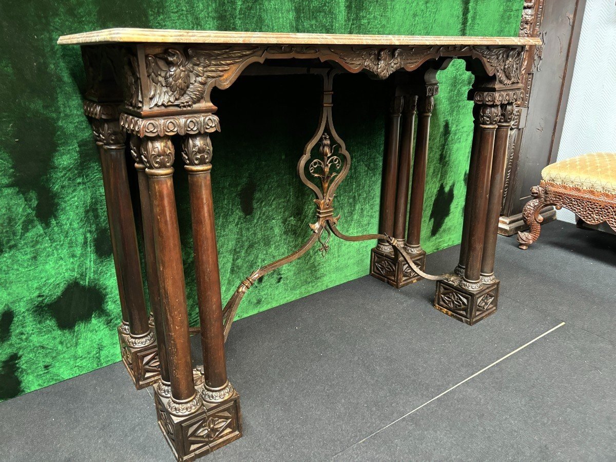 Decorative console/wall table in walnut 19thC. Special console with eagle sculptures in front and on both sides and fitted with 3 columns per leg. The 4 legs are connected with a wrought-iron decoration , the top is in marble Dimensions : Width : 131 cm