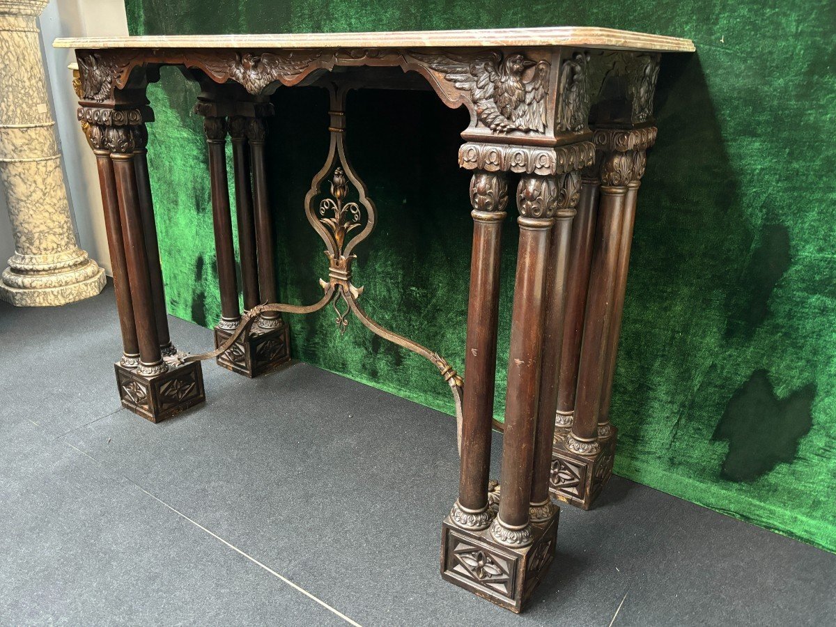 Decorative console/wall table in walnut 19thC. Special console with eagle sculptures in front and on both sides and fitted with 3 columns per leg. The 4 legs are connected with a wrought-iron decoration , the top is in marble Dimensions : Width : 131 cm