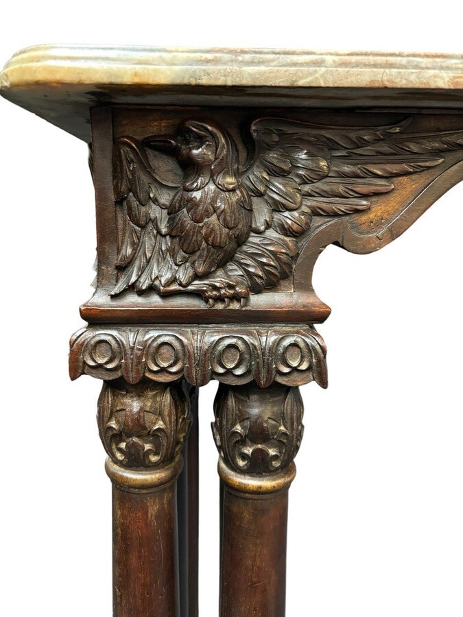 Decorative console/wall table in walnut 19thC. Special console with eagle sculptures in front and on both sides and fitted with 3 columns per leg. The 4 legs are connected with a wrought-iron decoration , the top is in marble Dimensions : Width : 131 cm