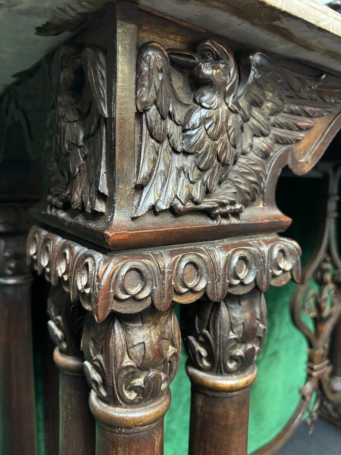 Decorative console/wall table in walnut 19thC. Special console with eagle sculptures in front and on both sides and fitted with 3 columns per leg. The 4 legs are connected with a wrought-iron decoration , the top is in marble Dimensions : Width : 131 cm