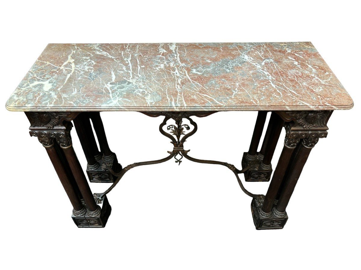Decorative console/wall table in walnut 19thC. Special console with eagle sculptures in front and on both sides and fitted with 3 columns per leg. The 4 legs are connected with a wrought-iron decoration , the top is in marble Dimensions : Width : 131 cm