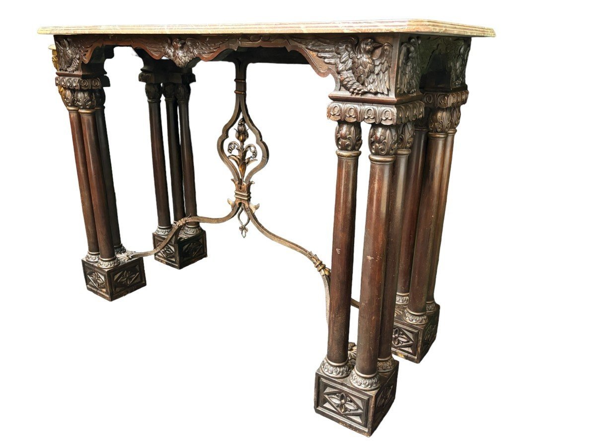 Decorative console/wall table in walnut 19thC. Special console with eagle sculptures in front and on both sides and fitted with 3 columns per leg. The 4 legs are connected with a wrought-iron decoration , the top is in marble Dimensions : Width : 131 cm