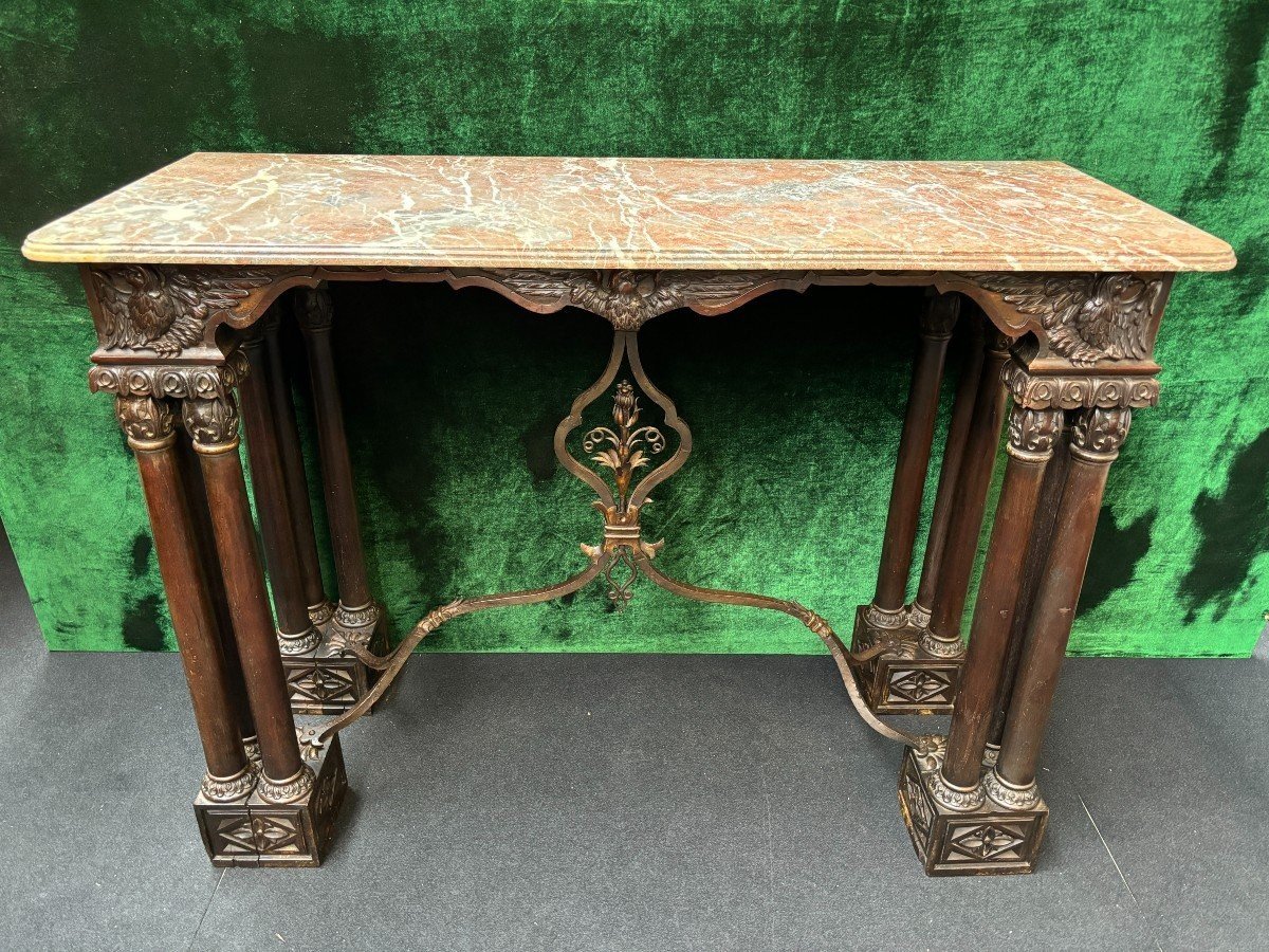 Decorative console/wall table in walnut 19thC. Special console with eagle sculptures in front and on both sides and fitted with 3 columns per leg. The 4 legs are connected with a wrought-iron decoration , the top is in marble Dimensions : Width : 131 cm