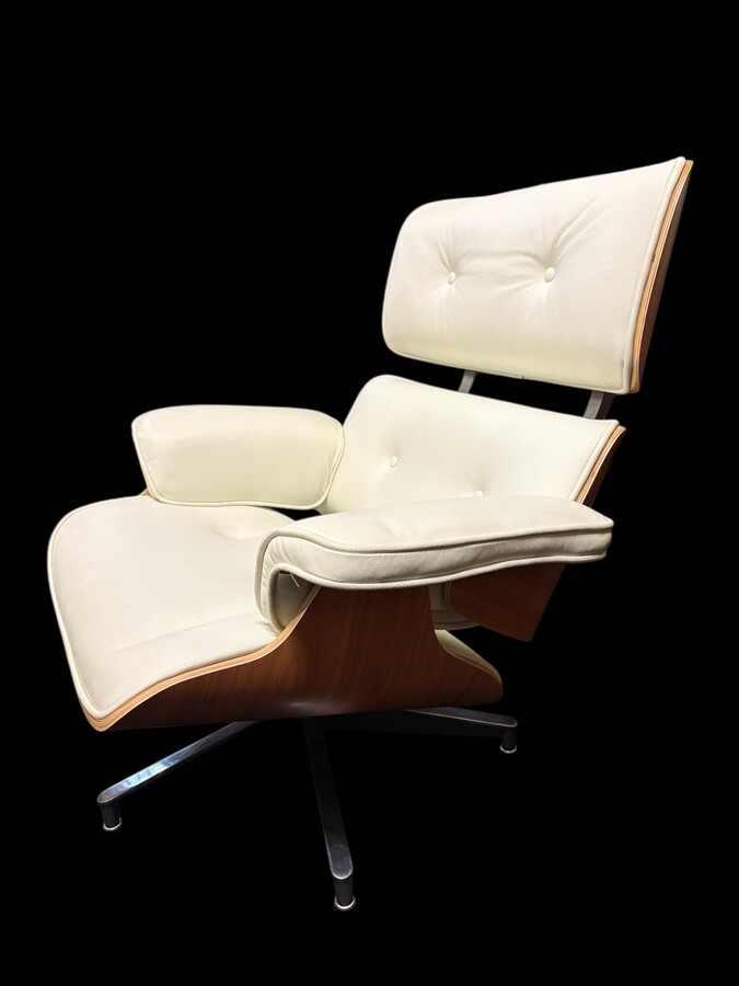Eames Lounge Chair with Ottoman footrest - in white leather with 21st century ash wood frame. Very elegant lounge chair in excellent condition. Lounge chair based on Eames design. Chair dimensions: Height: 86 cm Width: 89 cm Depth: 80 cm Footstool: 43 x 6