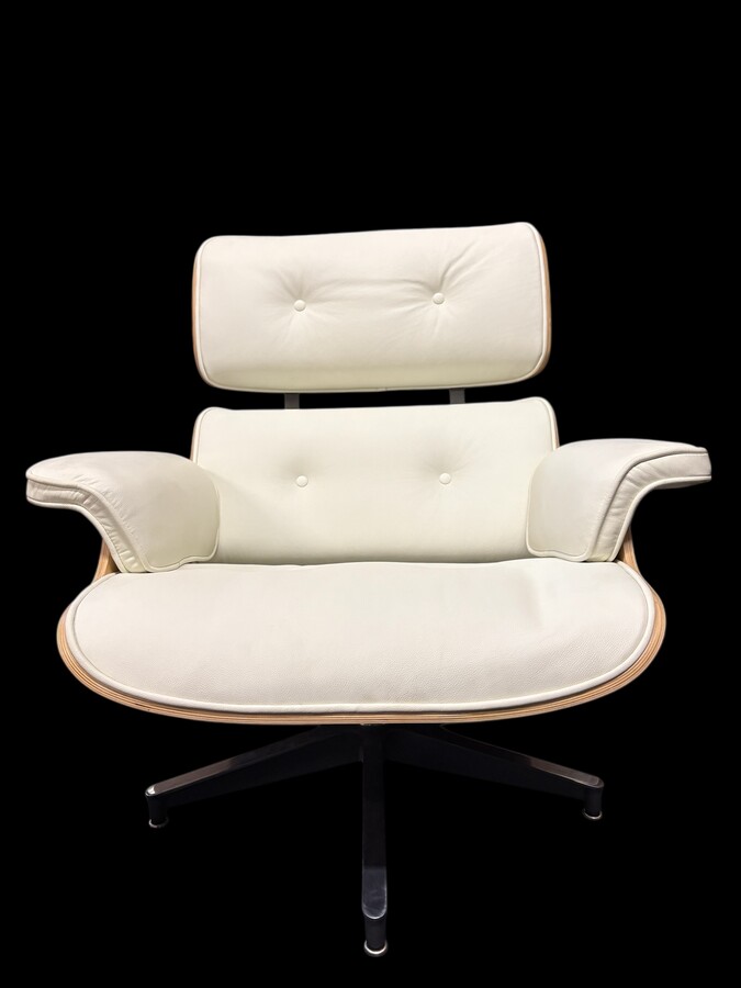 Eames Lounge Chair with Ottoman footrest - in white leather with 21st century ash wood frame. Very elegant lounge chair in excellent condition. Lounge chair based on Eames design. Chair dimensions: Height: 86 cm Width: 89 cm Depth: 80 cm Footstool: 43 x 6