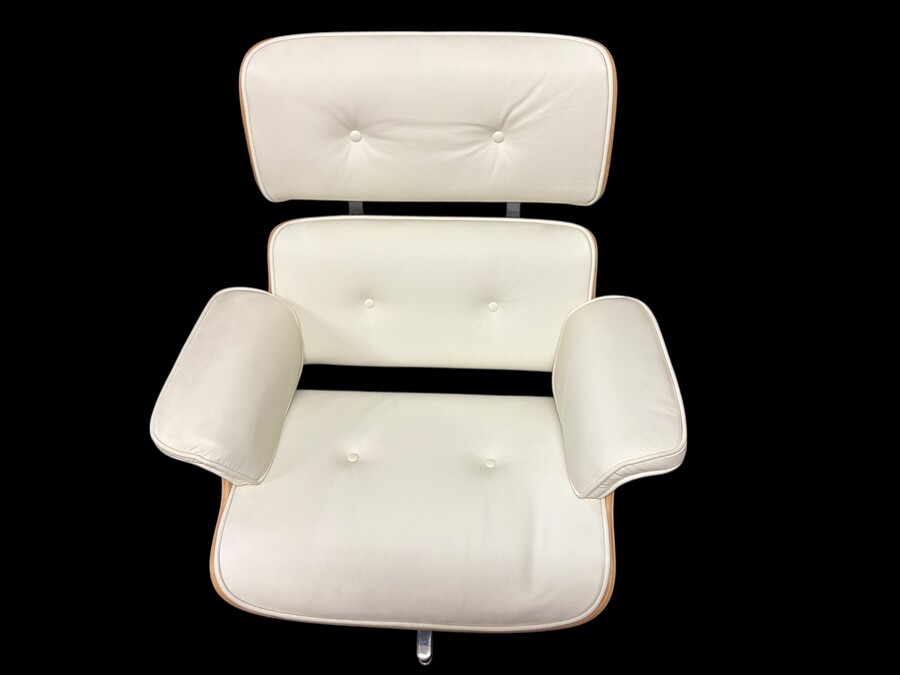 Eames Lounge Chair with Ottoman footrest - in white leather with 21st century ash wood frame. Very elegant lounge chair in excellent condition. Lounge chair based on Eames design. Chair dimensions: Height: 86 cm Width: 89 cm Depth: 80 cm Footstool: 43 x 6