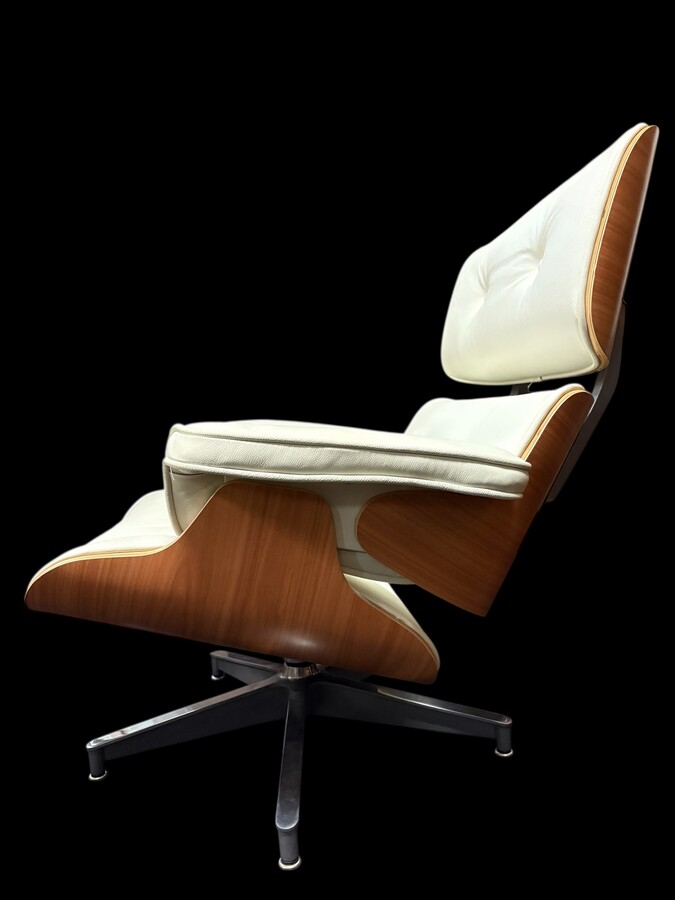 Eames Lounge Chair with Ottoman footrest - in white leather with 21st century ash wood frame. Very elegant lounge chair in excellent condition. Lounge chair based on Eames design. Chair dimensions: Height: 86 cm Width: 89 cm Depth: 80 cm Footstool: 43 x 6