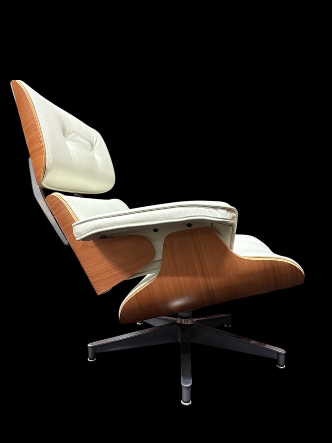 Eames Lounge Chair with Ottoman footrest - in white leather with 21st century ash wood frame. Very elegant lounge chair in excellent condition. Lounge chair based on Eames design. Chair dimensions: Height: 86 cm Width: 89 cm Depth: 80 cm Footstool: 43 x 6
