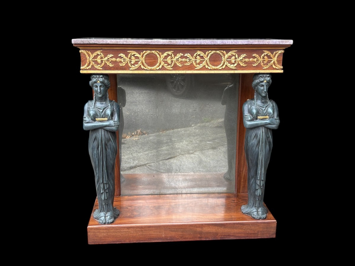 Elegant Empire-style mahogany console table, 19th century. Decorative Empire-style console table adorned with two large patinated female figures, gilded decorations, a mirror at the back and a special marble top.