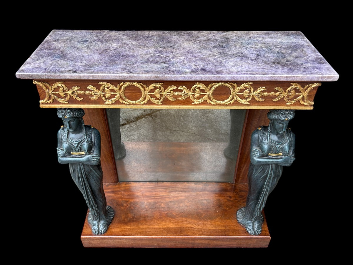 Elegant Empire-style mahogany console table, 19th century. Decorative Empire-style console table adorned with two large patinated female figures, gilded decorations, a mirror at the back and a special marble top.