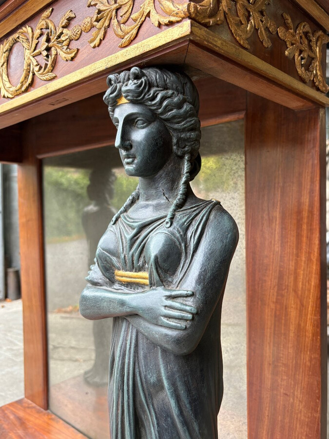 Elegant Empire-style mahogany console table, 19th century. Decorative Empire-style console table adorned with two large patinated female figures, gilded decorations, a mirror at the back and a special marble top.