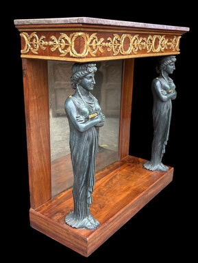 Elegant Empire-style mahogany console table, 19th century. Decorative Empire-style console table adorned with two large patinated female figures, gilded decorations, a mirror at the back and a special marble top.