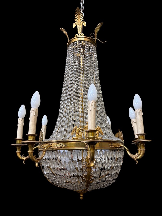 Empire-style chandelier Lighting provided by 8 inner lights and a ring of 8 outer lights. Beautiful gilded bronze frame. In good condition, with a few crystals missing. A lovely chandelier, made in France, 