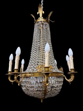 Empire-style chandelier Lighting provided by 8 inner lights and a ring of 8 outer lights. Beautiful gilded bronze frame. In good condition, with a few crystals missing. A lovely chandelier, made in France, 