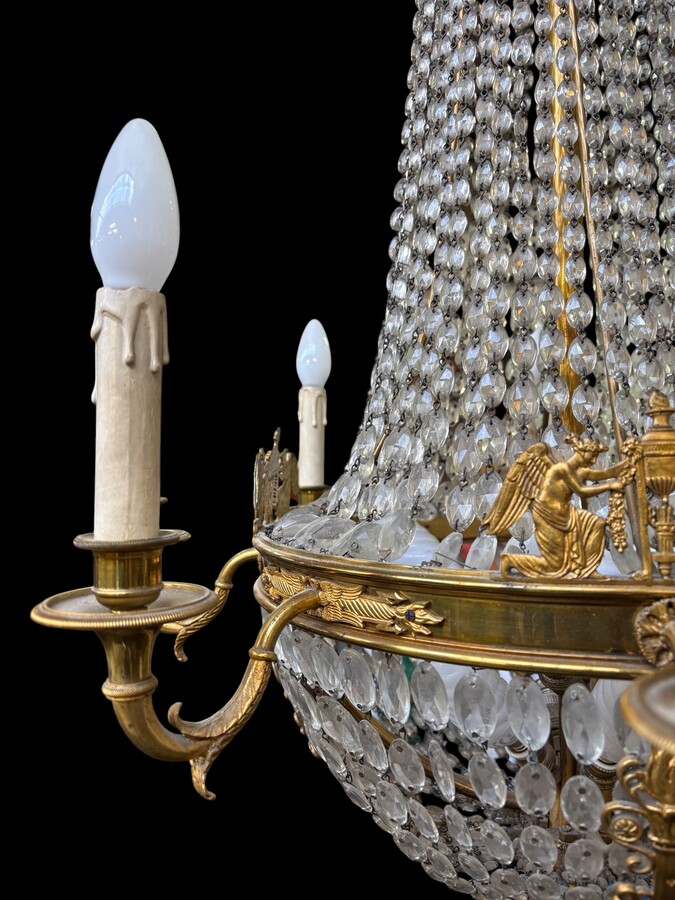 Empire-style chandelier Lighting provided by 8 inner lights and a ring of 8 outer lights. Beautiful gilded bronze frame. In good condition, with a few crystals missing. A lovely chandelier, made in France, 