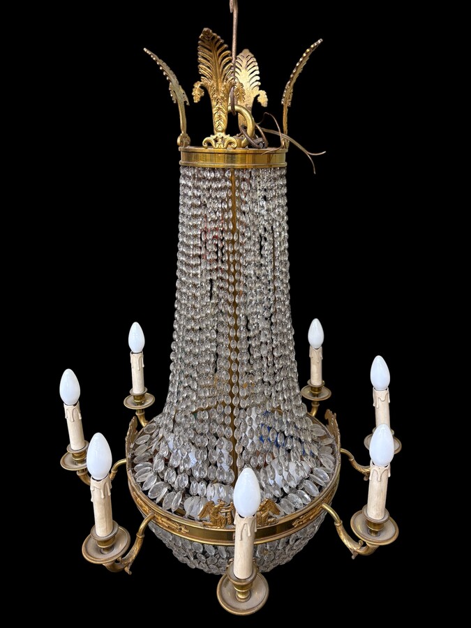Empire-style chandelier Lighting provided by 8 inner lights and a ring of 8 outer lights. Beautiful gilded bronze frame. In good condition, with a few crystals missing. A lovely chandelier, made in France, 