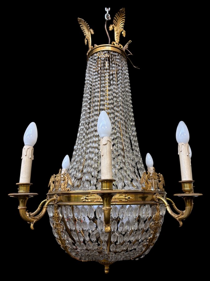 Empire-style chandelier Lighting provided by 8 inner lights and a ring of 8 outer lights. Beautiful gilded bronze frame. In good condition, with a few crystals missing. A lovely chandelier, made in France, 