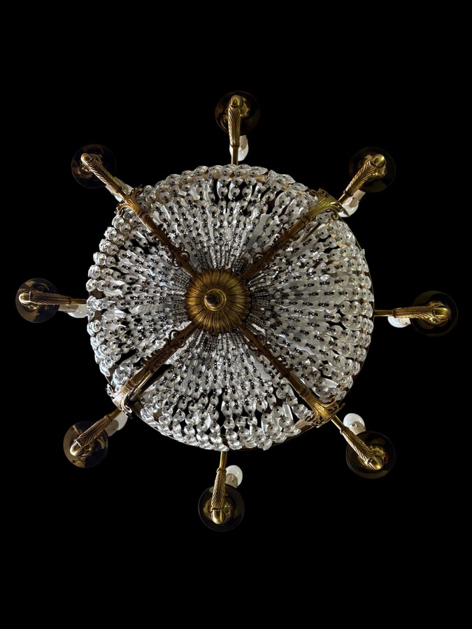 Empire-style chandelier Lighting provided by 8 inner lights and a ring of 8 outer lights. Beautiful gilded bronze frame. In good condition, with a few crystals missing. A lovely chandelier, made in France, 