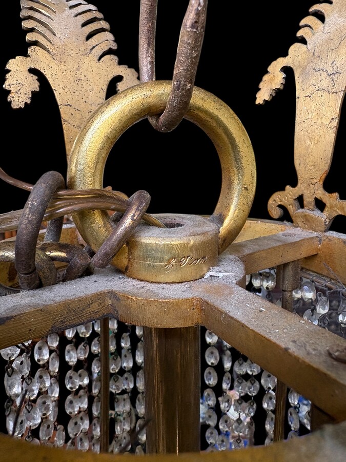 Empire-style chandelier Lighting provided by 8 inner lights and a ring of 8 outer lights. Beautiful gilded bronze frame. In good condition, with a few crystals missing. A lovely chandelier, made in France, 