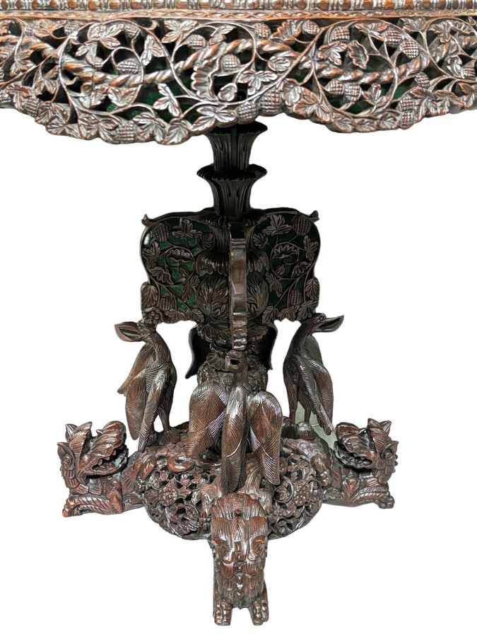 Finely sculpted centre table in hardwood 19th century. Decorated with dragons , birds , animals and temples Folding top , in good condition. Dimensions : Height : 78 cm Diameter top : 84 cm Nice table from Burma , 19thC.