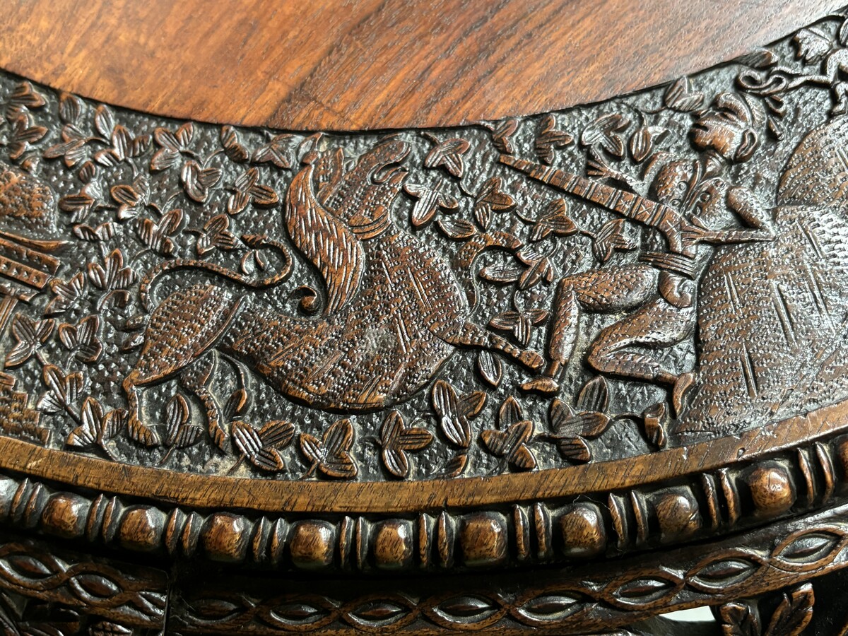 Finely sculpted centre table in hardwood 19th century. Decorated with dragons , birds , animals and temples Folding top , in good condition. Dimensions : Height : 78 cm Diameter top : 84 cm Nice table from Burma , 19thC.