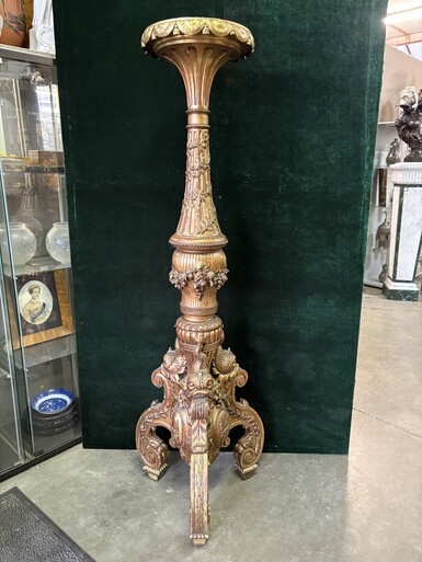 Large 19th-century gilded wooden candelabra (163 cm) Decorative candelabra with a stem, adorned with motifs, tendrils, garlands, French lilies, drapery and tassels, resting on three large legs decorated with mythological fish and scrolls.