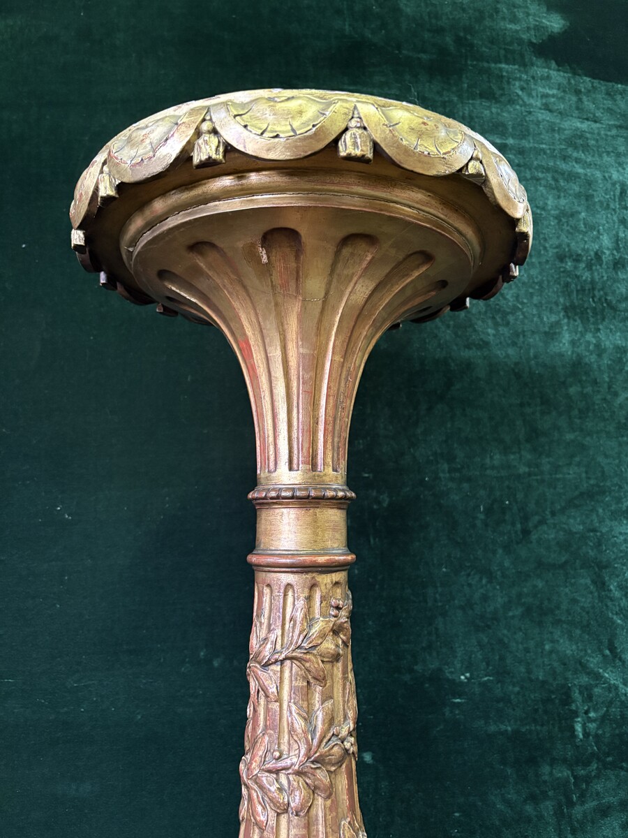 Large 19th-century gilded wooden candelabra (163 cm) Decorative candelabra with a stem, adorned with motifs, tendrils, garlands, French lilies, drapery and tassels, resting on three large legs decorated with mythological fish and scrolls.