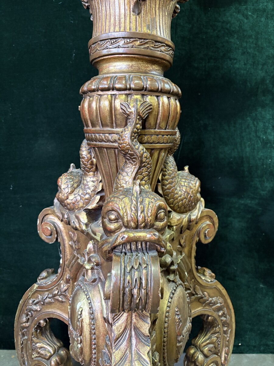 Large 19th-century gilded wooden candelabra (163 cm) Decorative candelabra with a stem, adorned with motifs, tendrils, garlands, French lilies, drapery and tassels, resting on three large legs decorated with mythological fish and scrolls.
