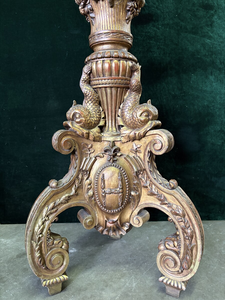 Large 19th-century gilded wooden candelabra (163 cm) Decorative candelabra with a stem, adorned with motifs, tendrils, garlands, French lilies, drapery and tassels, resting on three large legs decorated with mythological fish and scrolls.