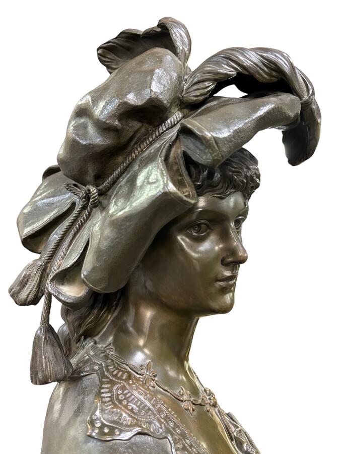 Large bust of a young woman wearing a feathered hat in patinated bronze, 19th century. The bust is signed by BEER (Friedrich Salomon Beer 1846-1912) a French-Austrian sculptor. It also bears the foundry's mark 