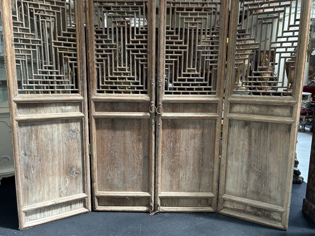 Large , decorative 4-piece door in solid wood 19thC. The doors have openwork panels at the top and closed panels at the bottom and have their original wrought iron fittings and a beautiful natural patina Dimensions : Height : 278 cm Total width : 240 cm