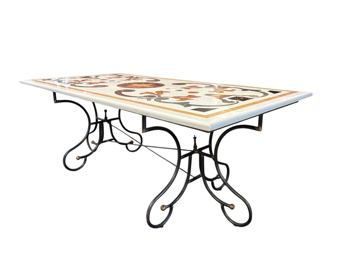 Large decorative table with inlaid marble top, 20th century. A beautiful table with a wrought iron base and a marble top inlaid with various types and colors of marble, with a large star in the center. Dimensions: 200 x 100 x 74 cm