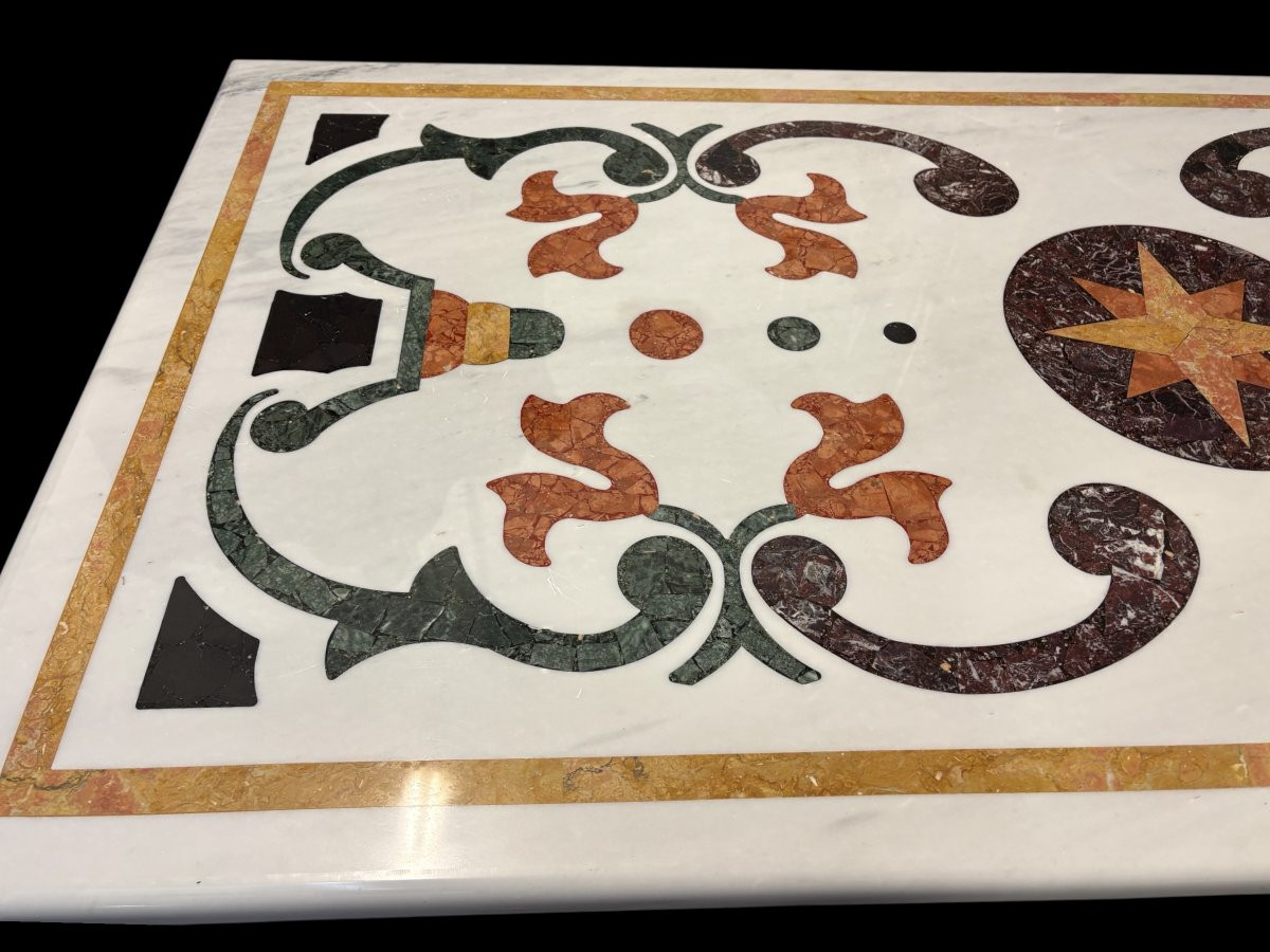 Large decorative table with inlaid marble top, 20th century. A beautiful table with a wrought iron base and a marble top inlaid with various types and colors of marble, with a large star in the center. Dimensions: 200 x 100 x 74 cm