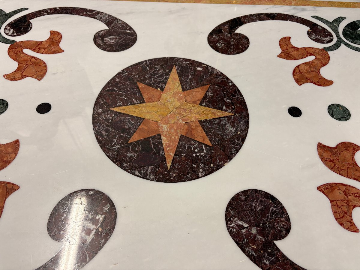 Large decorative table with inlaid marble top, 20th century. A beautiful table with a wrought iron base and a marble top inlaid with various types and colors of marble, with a large star in the center. Dimensions: 200 x 100 x 74 cm