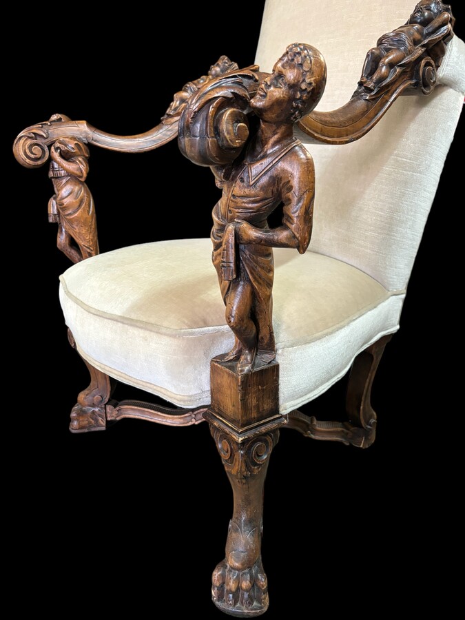 Large Italian armchair in walnut 19thC. Very decorative armchair with finely sculpted people and putti in walnut. Woodwork in good condition , fabric in used condition. Dimensions : Height : 121 cm Width : 86 cm Depth : 78 cm Italy , around 1860-1870