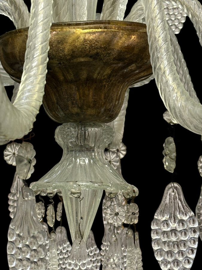Large Liège chandelier with 8 arms, 19th century (112 cm). Beautiful decorative glass chandelier with 8 large arms featuring light points decorated with small and large scrolls adorned with glass balls, grape cluster-shaped nuggets