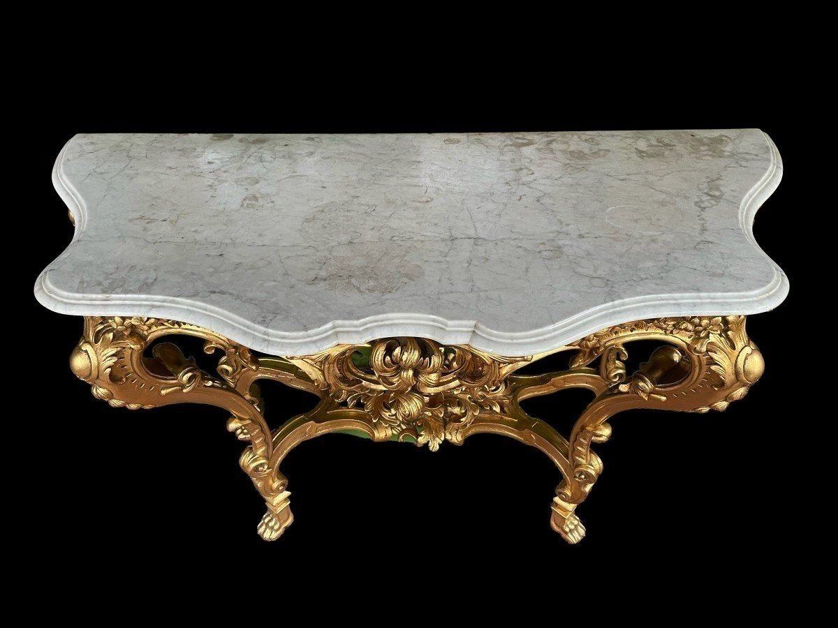 Large Louis XV style 4 legs console in gilded wood/stucco 19th century. Decorative console with a nice thick white marble top. The console and the marble top are in good condition and stand on 4 claw feet. It dates from about 1880-1900.