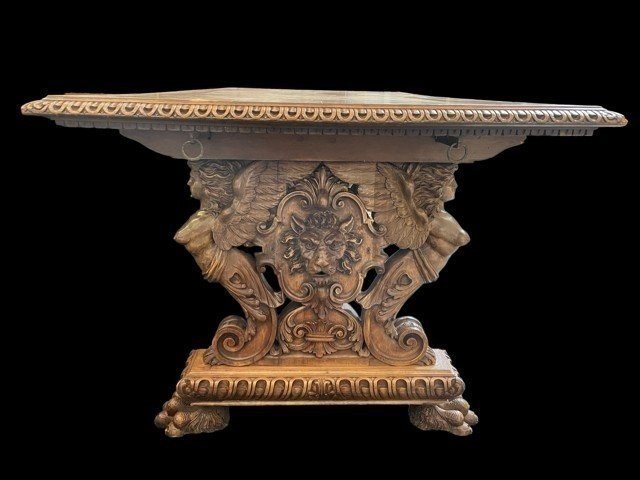 Large Table Style Renaissance In Walnut 19th Century. Very Decorative Table With Large Sculpted Winged Angels , Lion Heads And On The Lower Travers 2 Seated Putti With A Flower Basket. The Table Is In Good Condition