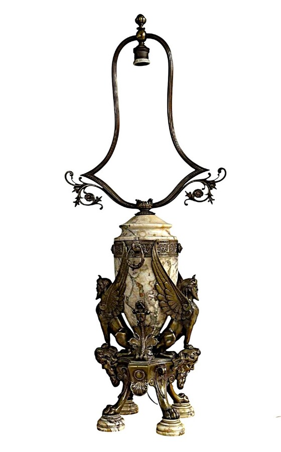 ‘Mythological Sphinx’ lamp base in bronze/marble, 1920. Decorative lamp base depicting two mythological sphinxes in bronze standing on a bearded man's head leaning against a large marble vase. Small defect