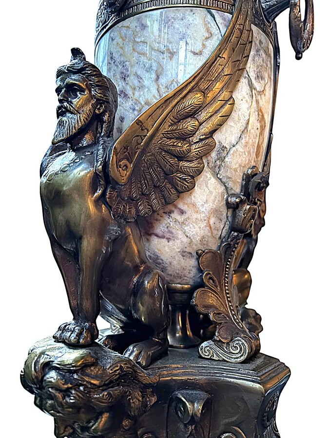 ‘Mythological Sphinx’ lamp base in bronze/marble, 1920. Decorative lamp base depicting two mythological sphinxes in bronze standing on a bearded man's head leaning against a large marble vase. Small defect