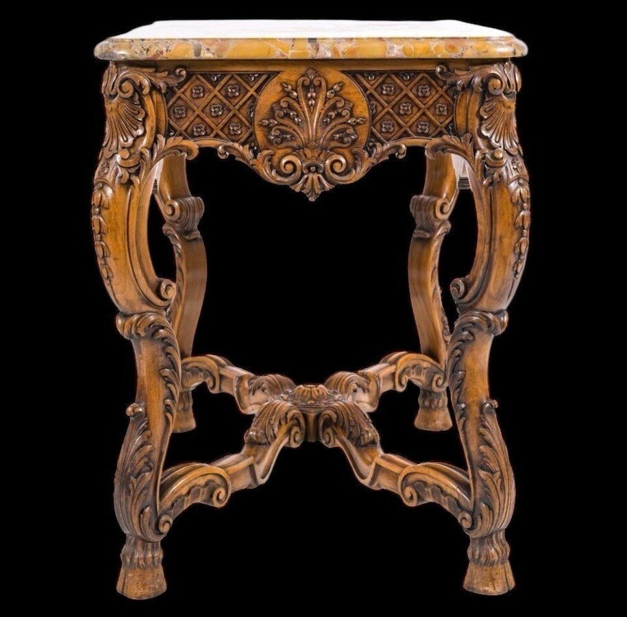 Ornately carved wooden coffee table with a marble top, circa 1920. Attractive oak coffee table/console with a Breche d'Aleppo marble top. Dimensions: Height: 80 cm. Width: 100 cm. Depth: 60 cm. In very good condition.